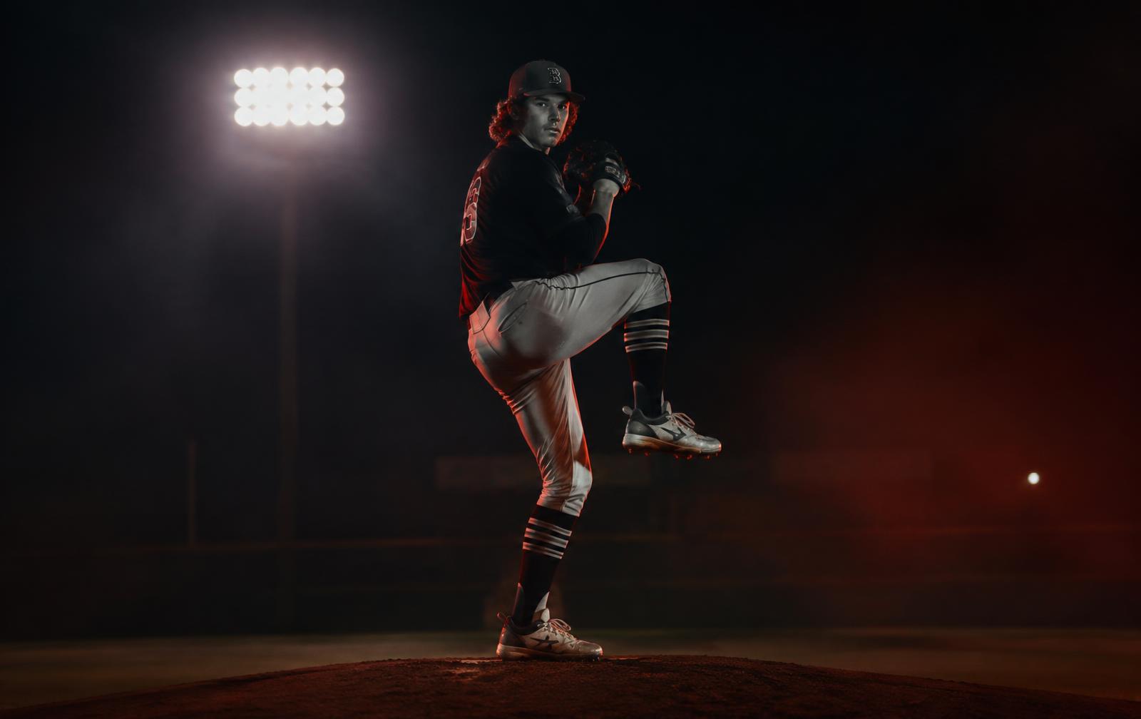Pitcher in windup under stadium lights